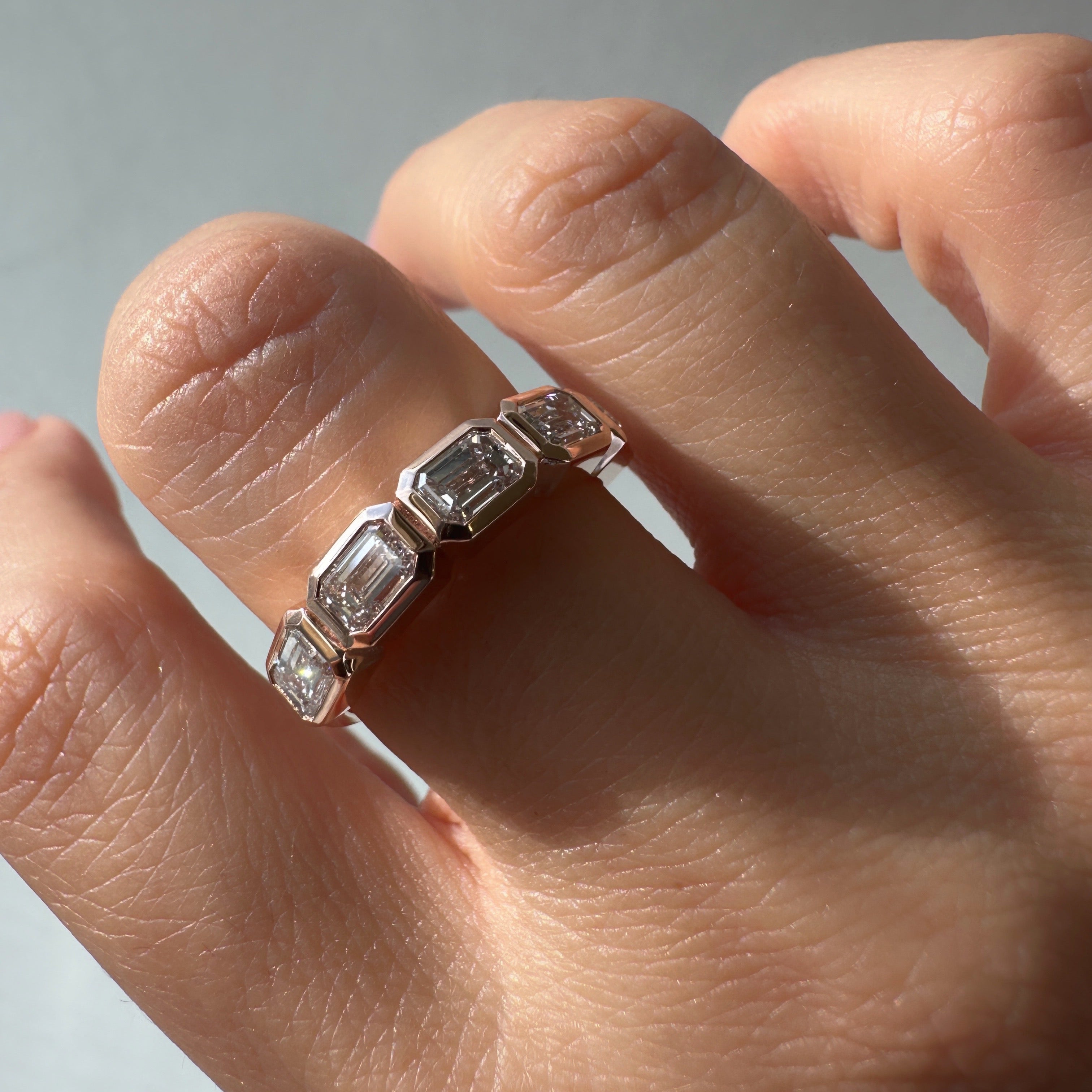 Five East-West Emerald Bezel Ring